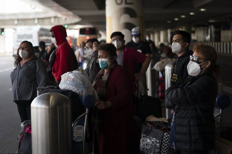 ASSOCIATED PRESS
                                Travelers waited for a shuttle bus to arrive at the Los Angeles International Airport in Los Angeles, today. The Los Angeles County Department of Public Health reported more than 3,500 new cases of COVID-19 on Sunday as the number of daily new cases tripled over the week.