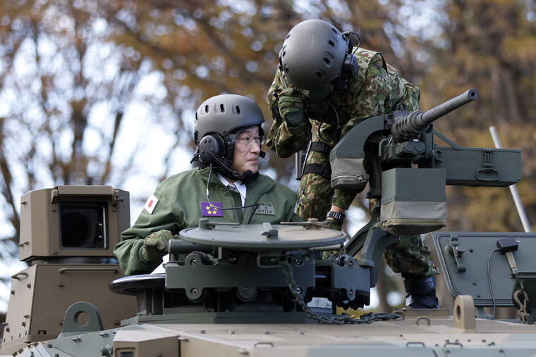 KIYOSHI OTA/POOL PHOTO VIA ASSOCIATED PRESS
                                Japan’s Prime Minister Fumio Kishida, left, rode on a Japan Ground Self-Defense Force (JGSDF) Type 10 tank during a review at the JGSDF Camp Asaka in Tokyo, Japan, Nov. 27. Kishida’s Cabinet approved record 5.4 trillion yen ($47 billion) budget, Friday, which includes research and development into future fighter jets and other “game-changer” arsenals as Japan bolsters its arms capability amid China’s rise and its tension with Taiwan.