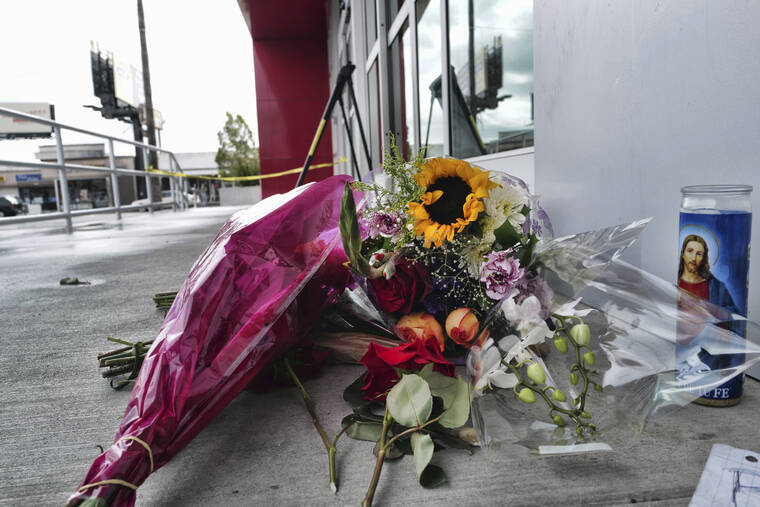 ASSOCIATED PRESS / DEC. 25
                                A votive candle and flowers are left for a teen who was fatally shot at a department store in the North Hollywood section of Los Angeles. The coroner’s office has identified the 14-year-old girl who was fatally shot by Los Angeles police the day before, when officers fired on an assault suspect and a bullet went through the wall and struck the girl as she was in a clothing store dressing room.