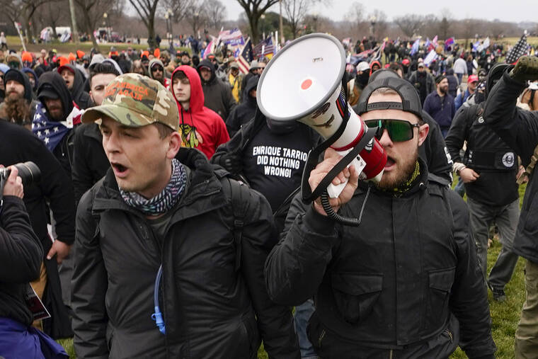 ASSOCIATED PRESS / JAN. 6
                                Proud Boys members Zachary Rehl, left, and Ethan Nordean, left, walk toward the U.S. Capitol in Washington, in support of President Donald Trump. A federal judge on Tuesday, Dec. 28 refused to dismiss an indictment charging four alleged leaders of the far-right Proud Boys, Ethan Nordean, Joseph Biggs, Zachary Rehl and Charles Donohoe, with conspiring to attack the U.S. Capitol to stop Congress from certifying President Joe Biden’s electoral victory.