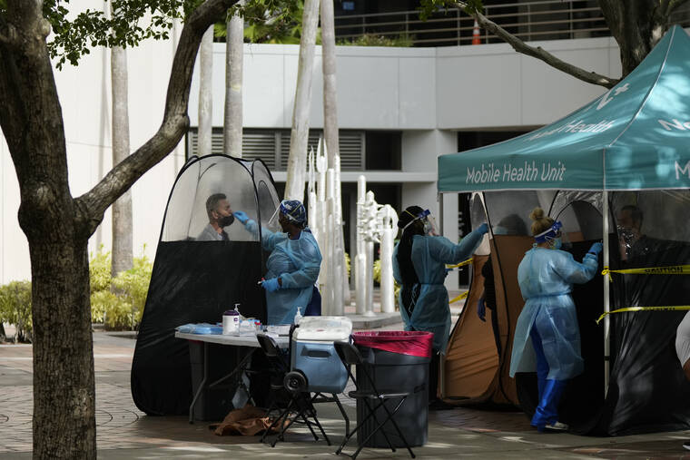ASSOCIATED PRESS
                                People were tested for COVID-19, at a walk-up testing site run by Nomi Health, Tuesday, in downtown Miami. More than a year after the vaccine was rolled out, new cases of COVID-19 in the U.S. have soared to the highest level on record at over 265,000 per day on average, a surge driven largely by the highly contagious omicron variant.