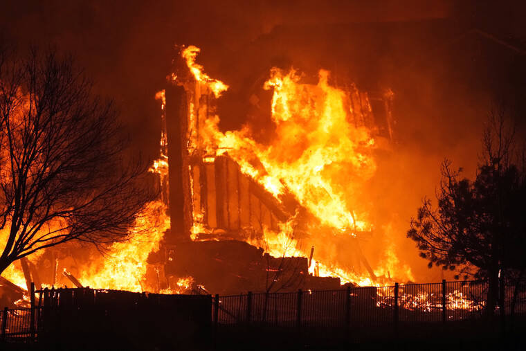 ASSOCIATED PRESS
                                Homes burn as a wildfire rips through a development near Rock Creek Village Thursday near Broomfield, Colo. An estimated 580 homes, a hotel and a shopping center have burned and tens of thousands of people were evacuated in wind-fueled wildfires in Boulder County.