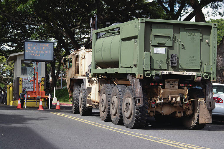 GEORGE F. LEE / GLEE@STARADVERTISER.COM
                                A military vehicle arrived at the Army’s Red Hill housing area to deliver drinking water to families affected by contamination of the Navy-­run water system that serves the community.