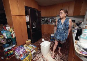 CINDY ELLEN RUSSELL / CRUSSELL@STARADVERTISER.COM
                                Chandra Sugitaya surveyed her kitchen after multiple flooding events inundated her family’s Noelani Street home in Pearl City.