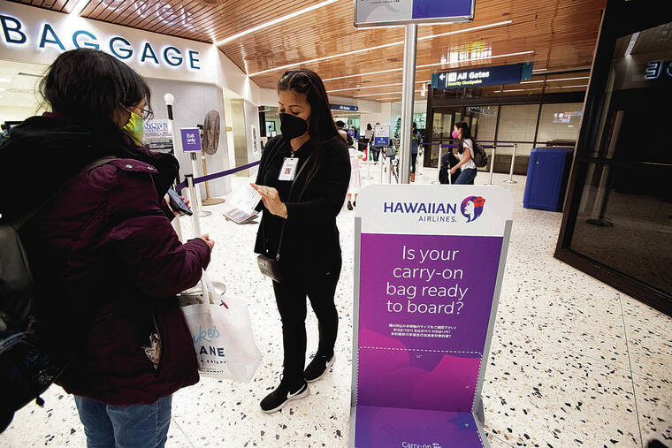 CINDY ELLEN RUSSELL / CRUSSELL@STARADVERTISER.COM
                                S.A.S. employee Mary Glen Fuerte assisted travelers Friday before they entered the TSA checkpoint at the Mauka Concourse of Daniel K. Ino­uye International Airport.