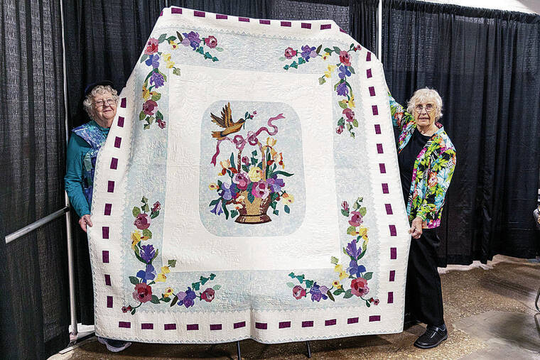 PHILADELPHIA INQUIRER / TNS
                                Beverley MacGown, right, and longtime friend and fellow quilter Jean Donahue, both of Concord, N.H., hold up MacGown’s quilt “Baskets & Butterflies” during the Pennsylvania National Quilt Extravaganza at the Greater Philadelphia Expo Center in Oaks, Pa. The quilt won a blue ribbon at the 2004 Vermont Quilt Festival.