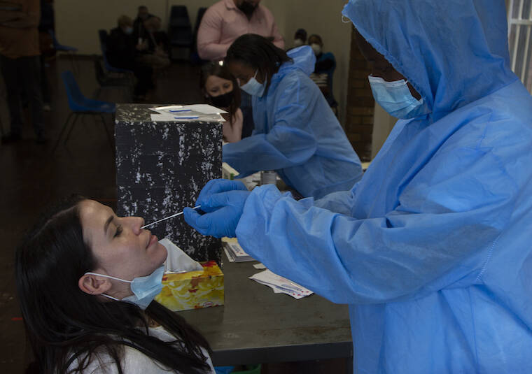 DENIS FARRELL/AP
                                A nasal swab is taken to test for COVID-19 at a site near Johannesburg.