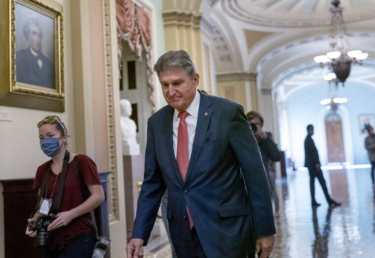 ASSOCIATED PRESS
                                Sen. Joe Manchin, D-W.Va., walks to a caucus lunch at the Capitol in Washington on Friday.