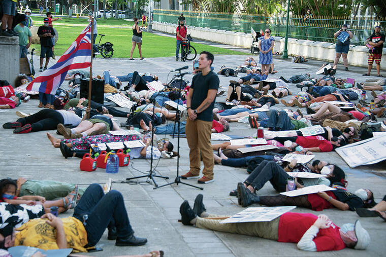 CRAIG T. KOJIMA / CKOJIMA@STARADVERTISER.COM
                                Jamaica Osorio of UH Manoa Indigenous Politics sang “Aloha ‘Oe” while protesters sprawled on the ground around him. People gathered Friday at the state Capitol calling for the Red Hill Fuel Storage Facility to be shut down.