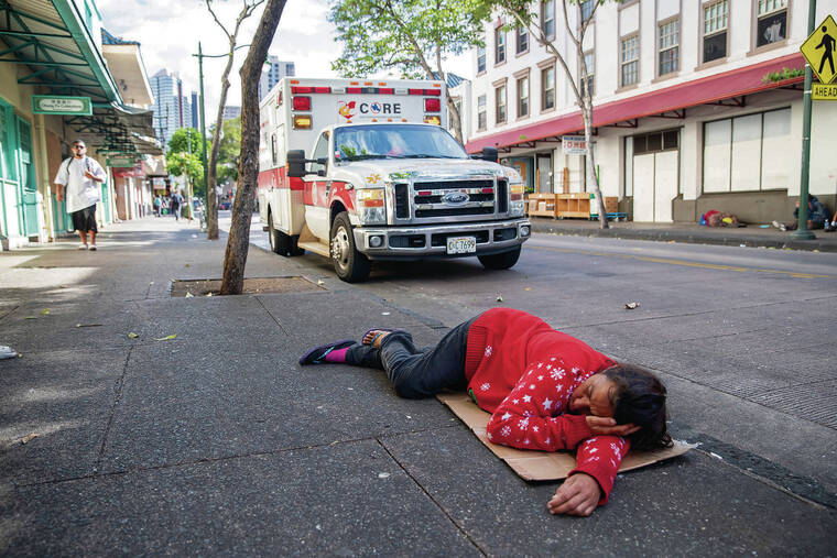 CINDY ELLEN RUSSELL / CRUSSELL@STARADVERTISER.COM
                                A woman sleeps on the sidewalk of North Hotel Street. Parked behind her is the CORE ambulance.