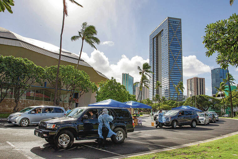 CINDY ELLEN RUSSELL / CRUSSELL@STARADVERTISER.COM
                                On Friday, cars lined Pensacola Street as people waited to get tested for the coronavirus at the Blaisdell Center parking lot. Above, workers administered COVID-19 tests at the site.