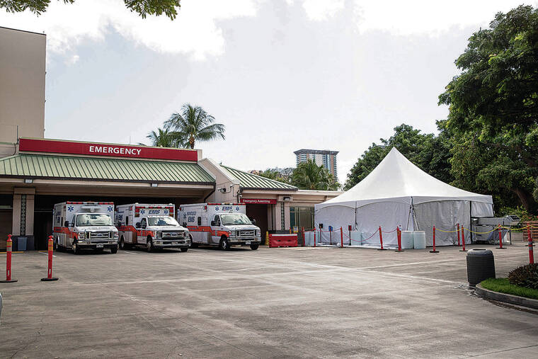 CINDY ELLEN RUSSELL / CRUSSELL@STARADVERTISER.COM
                                The Queen’s Medical Center recently erected a triage tent at the emergency dock area to provide additional space to separate non-COVID-19 patients from those who are infected.