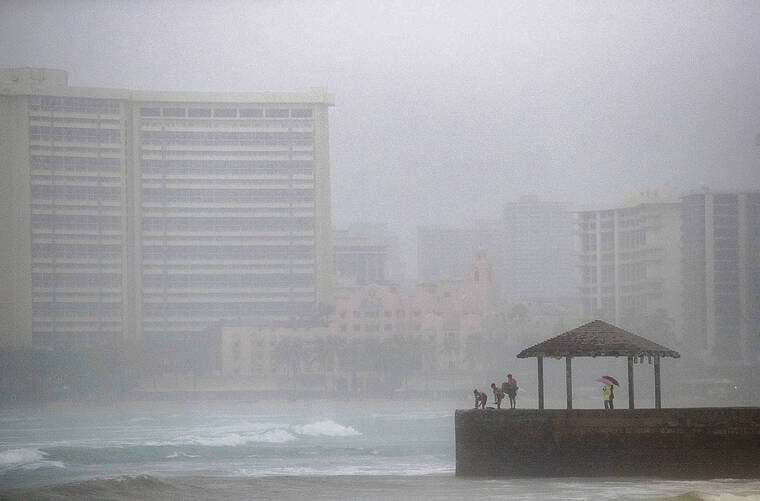 CINDY ELLEN RUSSELL / CRUSSELL@STARADVERTISER.COM
                                The powerful kona low weather system caused flooding, power outages and property damage across the islands on Monday, with Oahu experiencing the brunt of the slow-moving storm. Above, the shoreline of Waikiki was barely visible during a downpour.