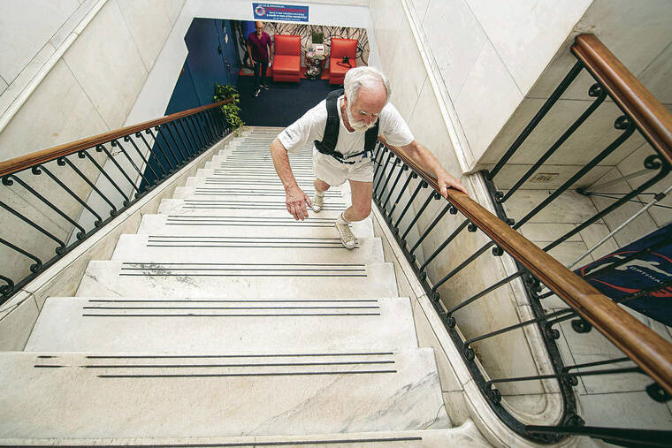 TRIBUNE NEWS SERVICE 
                                Above, David Pallett, 77, works out on the steps of Optimal Sport gym during a session with personal trainer Jim Hart.