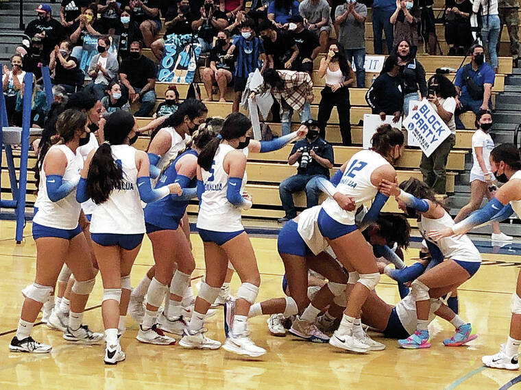PAUL HONDA / PHONDA@STARADVERTISER.COM
                                The Moanalua girls volleyball team stormed the court to celebrate its five-set victory over Mililani on Tuesday at Moanalua’s gym.