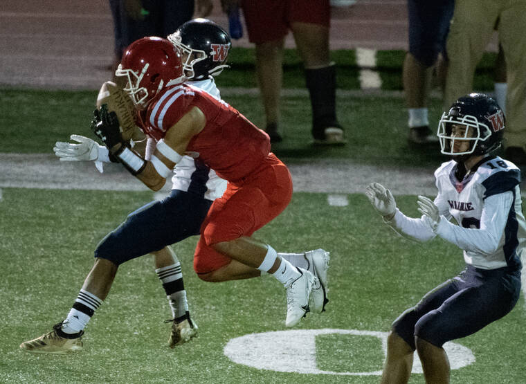 CRAIG T. KOJIMA / CKOJIMA@STARADVERTISER.COM
                                Waianae’s Zavier Vincent and Malachi Tapaoan defended a pass intended for Kahuku’s Jamerus Tai Hook during the first quarter.