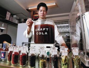 JAPAN NEWS-YOMIURI 
                                Company owner Takahide Kobayashi stirs his cola syrup, which took him more than two years to develop.