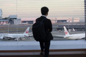ASSOCIATED PRESS
                                A man looks at Japan Airlines planes parked at Haneda international Airport in Tokyo.