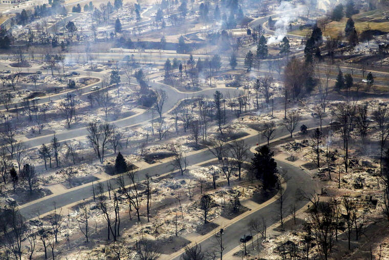 COLORADO PUBLIC RADIO VIA AP
                                A view of a Boulder County neighborhood that was destroyed by a wildfire is seen from a Colorado National Guard helicopter during a flyover by Gov. Jared Polis on Friday, Dec. 31, 2021.