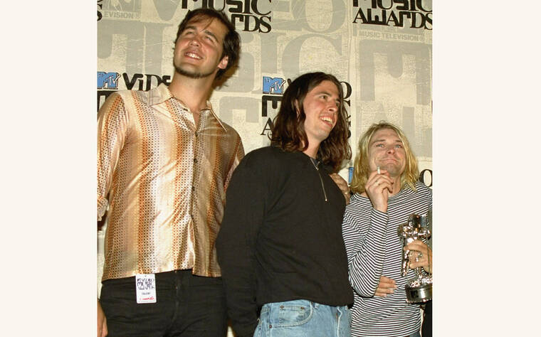ASSOCIATED PRESS / 1993
                                Nirvana band members, from left, Krist Novoselic, Dave Grohl and Kurt Cobain pose after receiving an award for best alternative video at the 10th annual MTV Video Music Awards in Universal City, Calif.