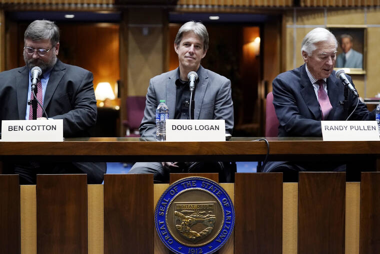 ASSOCIATED PRESS / 2021
                                Cyber Ninjas CEO Doug Logan, center, is flanked by Ben Cotton, left, founder of digital security firm CyFIR, and Randy Pullen, right, the former Chairman of the Arizona Republican Party, prior to the Arizona Senate Republicans hearing review of the 2020 presidential election results in Maricopa County at the Arizona Capitol in Phoenix, Sept. 24.