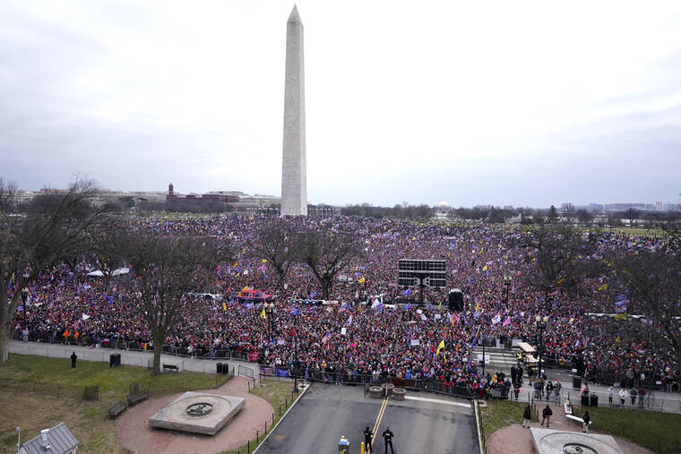 ASSOCIATED PRESS / 2021
                                With the Washington Monument in the background, people attend a rally in support of President Donald Trump on Jan. 6, in Washington.