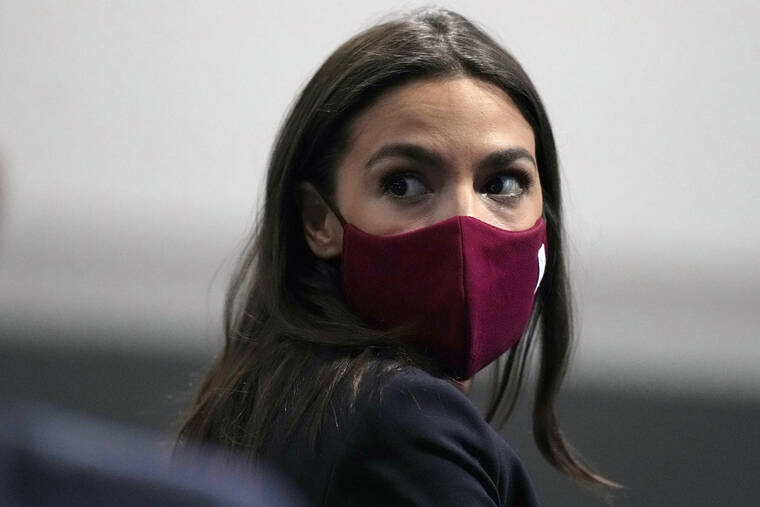 ASSOCIATED PRESS
                                U.S. Rep. Alexandria Ocasio-Cortez listened to a question at the COP26 U.N. Climate Summit, in Glasgow, Scotland, Nov. 10. Ocasio-Cortez tested positive for COVID-19 and “is experiencing symptoms and recovering at home,” her office said in a statement Sunday, Jan. 9, 2022.