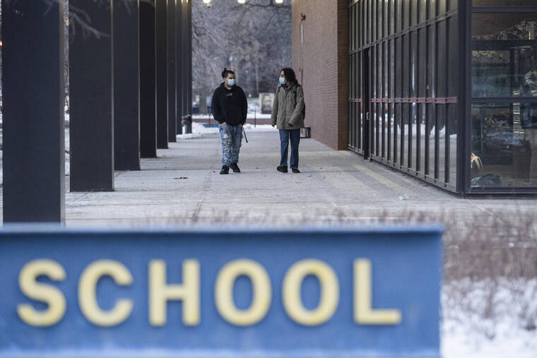 CHICAGO SUN-TIMES / AP
                                Students walk outside Roberto Clemente Community Academy in the Ukrainian Village neighborhood on the first day back to school, Wednesday, Jan. 12, in Chicago.