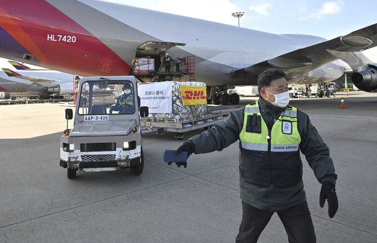 POOL VIA AP
                                Workers transport a cargo shipment containing the first batches of Pfizer’s antiviral COVID-19 pill, Paxlovid, at a cargo terminal at the Incheon International Airport, west of Seoul, South Korea, on Thursday.