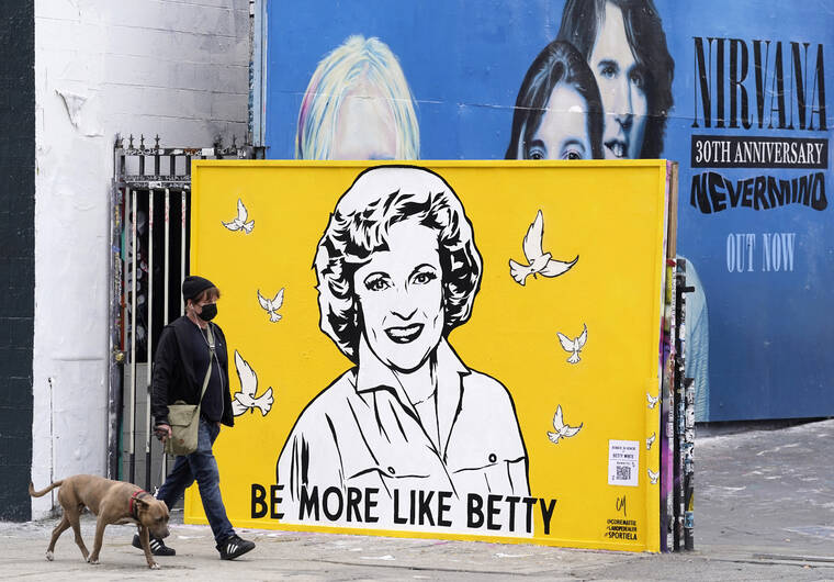 ASSOCIATED PRESS
                                A man walked a dog past a new mural of the late actress Betty White by artist Corie Mattie, Tuesday, in Los Angeles. Mattie added a QR code to the mural so people walking by can donate to the local shelter Wagmor Pets Dog Rescue in honor of White, an animal welfare advocate. White died Dec. 31, 2021, at age 99.