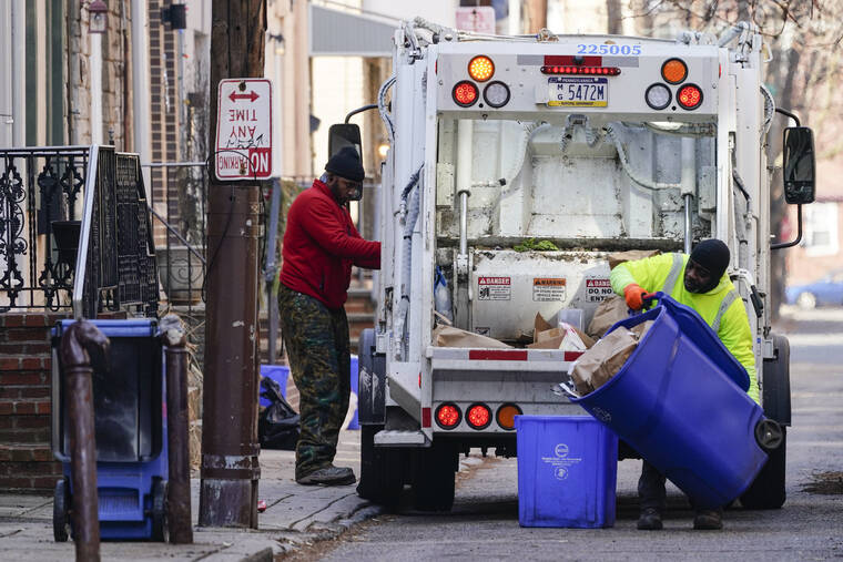 ASSOCIATED PRESS / JAN. 13
                                Municipal sanitation workers collect trash in Philadelphia.
