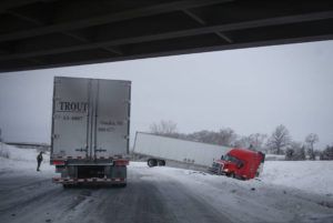 THE DES MOINES REGISTER / AP
                                A semi accident holds up traffic on Interstate 80 near Des Moines, Iowa after a winter storm dumped several inches of snow across central Iowa.
