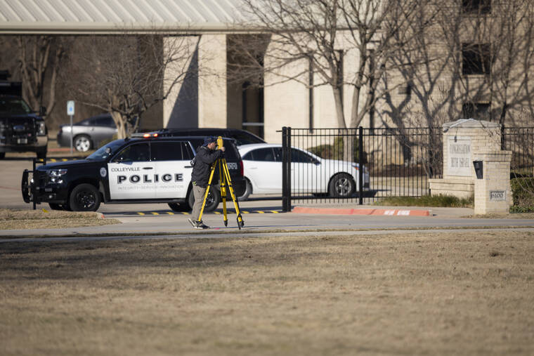 ASSOCIATED PRESS
                                Law enforcement process the scene in front of the Congregation Beth Israel synagogue today in Colleyville, Texas. A man held hostages for more than 10 hours Saturday inside the temple. The hostages were able to escape and the hostage taker was killed. FBI Special Agent in Charge Matt DeSarno said a team would investigate “the shooting incident.”