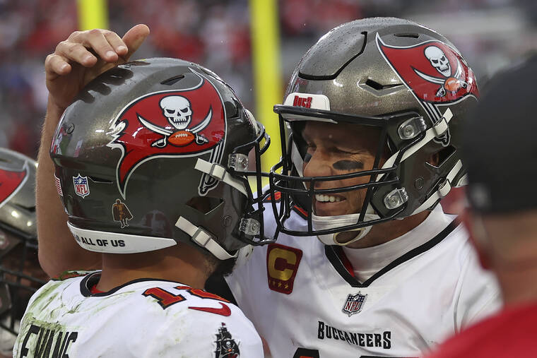ASSOCIATED PRESS
                                Tampa Bay Buccaneers quarterback Tom Brady, right, celebrates with wide receiver Mike Evans after Evans caught a touchdown pass against the Philadelphia Eagles during the second half of an NFL wild-card football game today in Tampa, Fla.
