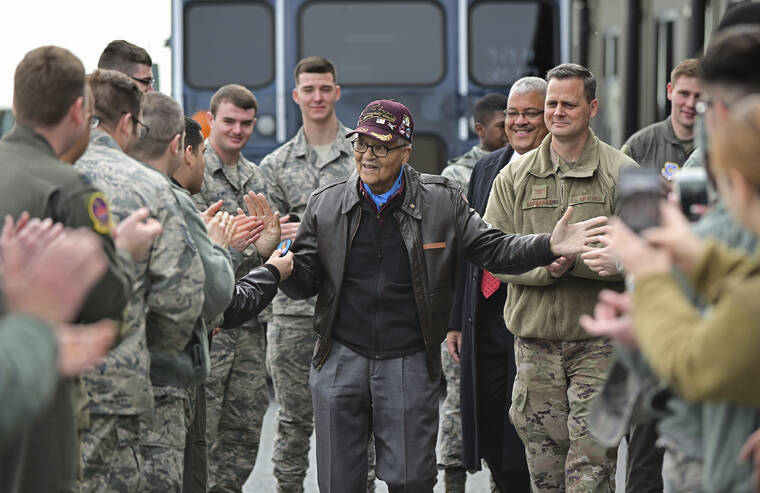 ASSOCIATED PRESS / DECEMBER 2019
                                Retired U.S. Air Force Col. Charles McGee, center, a decorated veteran of three wars, receives a congratulatory send off after visiting with 436 Aerial Port Squadron personnel at Dover Air Force Base to help celebrate his 100th birthday in Dover, Delaware. McGee, one of the last surviving Tuskegee Airmen who flew 409 fighter combat missions over three wars, died Sunday, Jan. 16. He was 102.