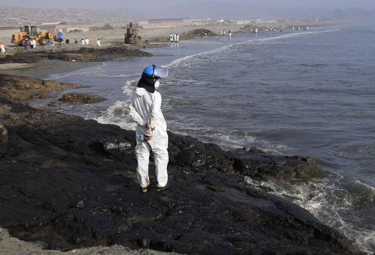 ASSOCIATED PRESS
                                A workers stand on a rock covered with oil as other help with the clean up at Cavero beach in Ventanilla, Callao, Peru. Unusual high waves that authorities attribute to the eruption of the undersea volcano in Tonga caused the spill on the Peruvian Pacific coast as a ship was loading oil into La Pampilla refinery on Sunday.