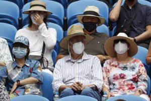 ASSOCIATED PRESS
                                Masked spectators watch first-round matches on Rod Laver Arena at the Australian Open tennis championships in Melbourne, Australia, Monday.