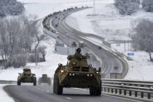 ASSOCIATED PRESS
                                A convoy of Russian armored vehicles moved along a highway in Crimea, today. Russia has concentrated an estimated 100,000 troops with tanks and other heavy weapons near Ukraine in what the West fears could be a prelude to an invasion.