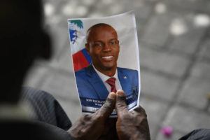 ASSOCIATED PRESS / JULY 20
                                A person holds a photo of the late Haitian President Jovenel Moise during his memorial ceremony at the National Pantheon Museum in Port-au-Prince, Haiti.
