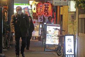 ASSOCIATED PRESS / JAN. 19
                                People wearing face masks to help protect against the spread of the coronavirus walk on a street lined with bars and restaurants in Tokyo.