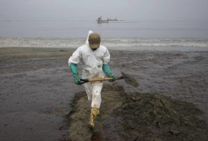 ASSOCIATED PRESS
                                A worker dressed in a protective suit cleans Conchitas Beach contaminated by an oil spill in Ancon, Peru, today.