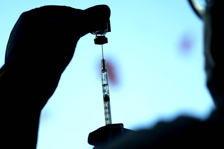 ASSOCIATED PRESS
                                A dose of a Pfizer COVID-19 vaccine was prepared at Lurie Children’s Hospital, Nov. 5, in Chicago. Three studies released today offered more evidence that COVID-19 vaccines are standing up to the omicron variant, at least among people who received booster shots.