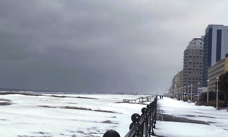 THE VIRGINIAN-PILOT / AP
                                Snow covers the Virginia Beach oceanfront, Saturday, in Virginia Beach, Va.