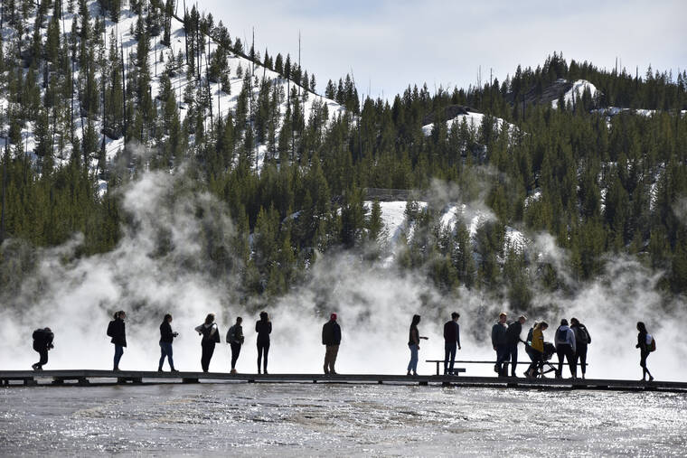 ASSOCIATED PRESS Visitors are seen at Grand Prismatic Spring in Yellowstone National Park, Wyo. on May 1. Yellowstone Superintendent Cam Sholly says officials want to use the parks 150th anniversary this year to recognize the many American Indian nations that lived in the area for thousands of years before the park was created.