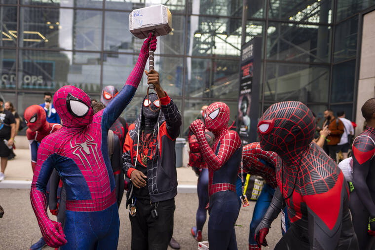 ASSOCIATED PRESS
                                Attendees dressed as Spider-Man gather during New York Comic Con at the Jacob K. Javits Convention Center in New York last year. After spending one weekend in second place, “Spider-Man: No Way Home” proved it still had some fight left. Sony’s superhero juggernaut swung back to first place in its sixth weekend in theaters and became the sixth highest grossing film of all time, globally, according to studio estimates.