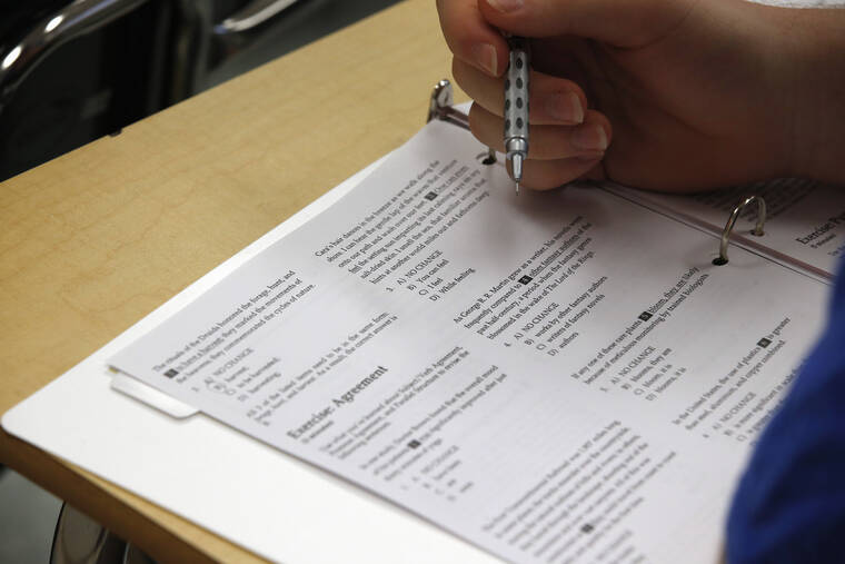 ASSOCIATED PRESS
                                A student looked at questions, in January 2016, during a college test preparation class at Holton Arms School in Bethesda, Md. The SAT exam will move from paper and pencil to a digital format, administrators announced Tuesday, Jan. 25, 2022, saying the shift will boost its relevancy as more colleges make standardized tests optional for admission.