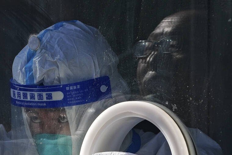 ASSOCIATED PRESS / JAN. 25
                                A medical worker wearing protective gear collects a sample from a resident at a coronavirus test site in Xichen District in Beijing.