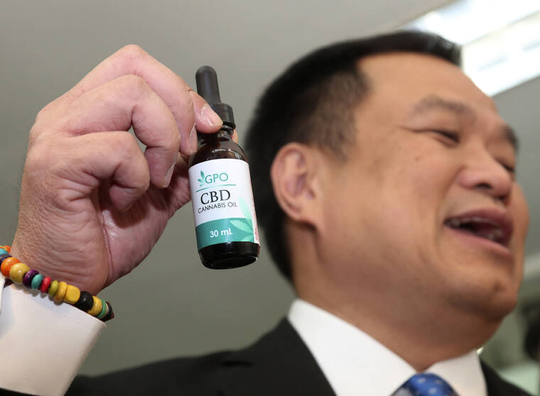 ASSOCIATED PRESS / 2019
                                Thailand’s Public Health Minister Anutin Chanvirakul shows off a bottle of extracted cannabis oil during a press conference at his ministry in Bangkok, Thailand, Wednesday, Aug. 7.