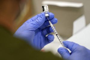 ASSOCIATED PRESS / 2021
                                A healthcare worker fills a syringe with the Pfizer COVID-19 vaccine at Jackson Memorial Hospital in Miami.