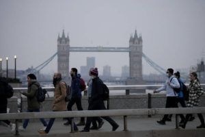 ASSOCIATED PRESS / JAN. 24
                                Workers walk over London Bridge towards the City of London financial district, backdropped by Tower Bridge, during the morning rush hour, in London.